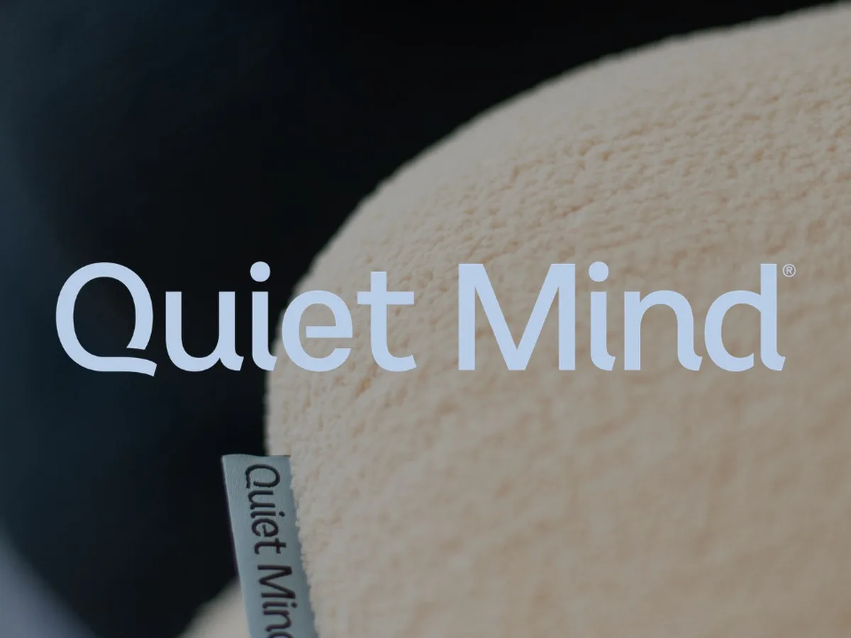 Quiet Mind weighted pillow with the brand wordmark